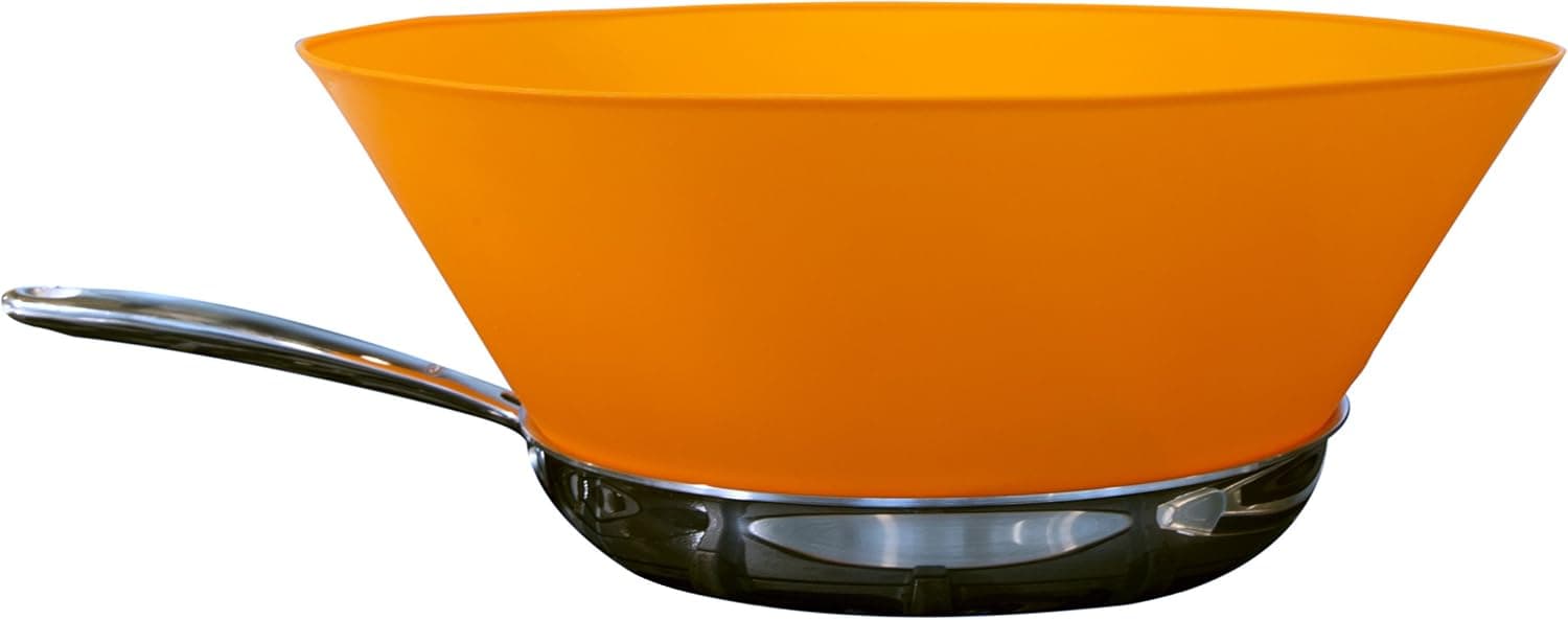 Orange Frywall silicone splatter guard standing around the inside edge of a frying pan