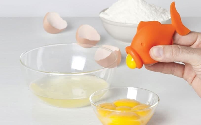 Orange Peleg YolkFish separating an egg yolk over a glass bowl