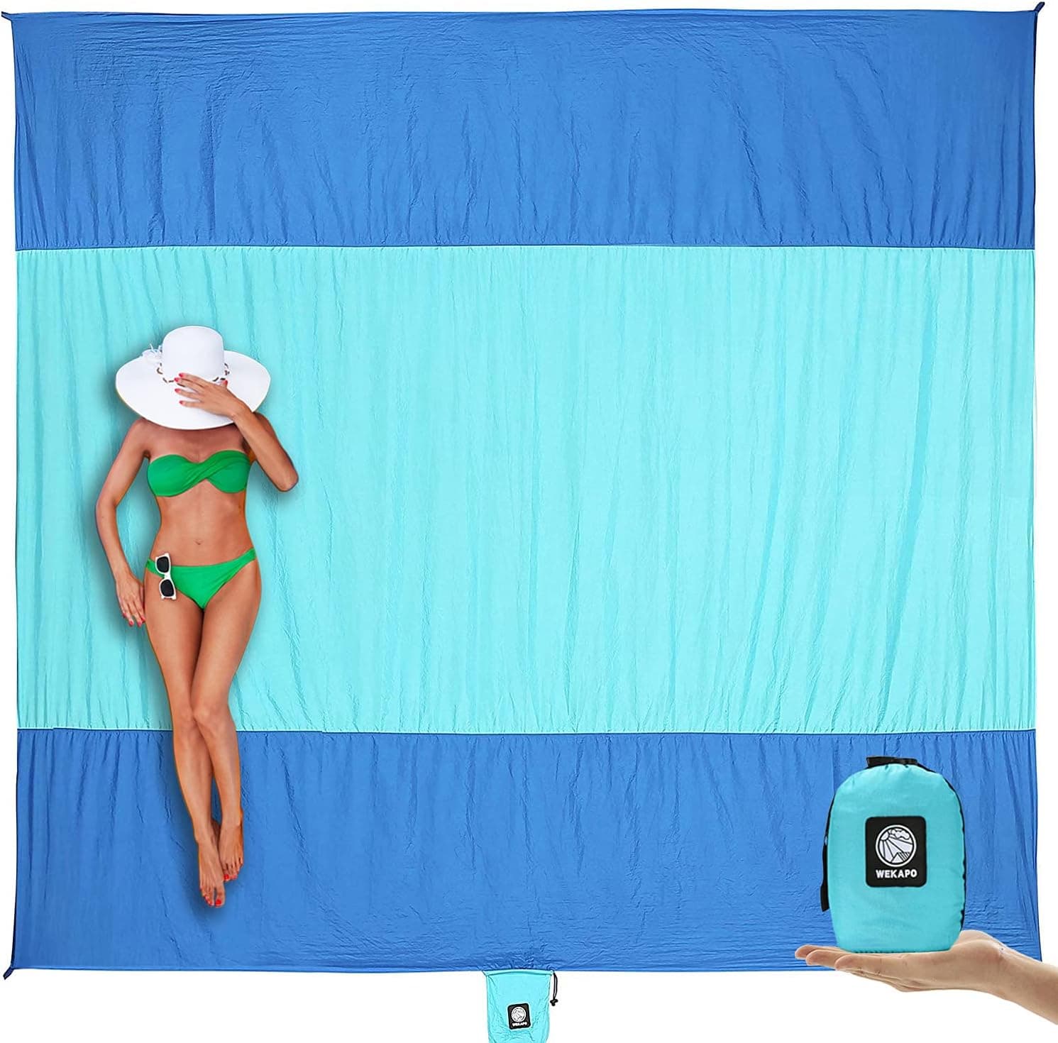 Blue WEKAPO oversized beach blanket displayed with its compact storage pouch